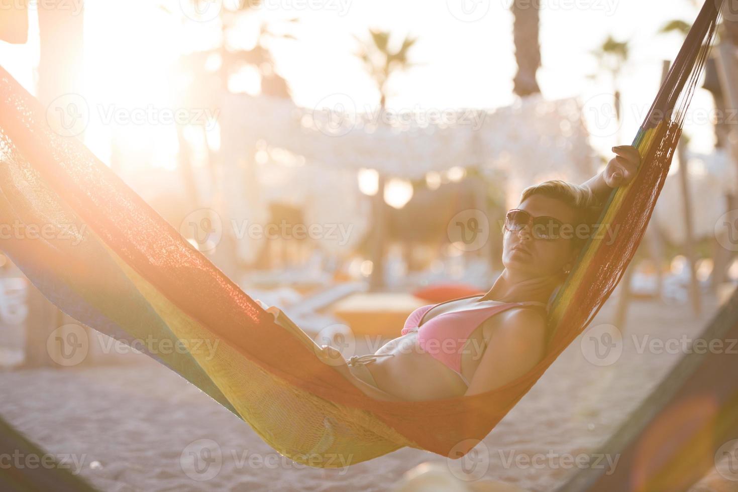 relaxed woman laying in hammock photo