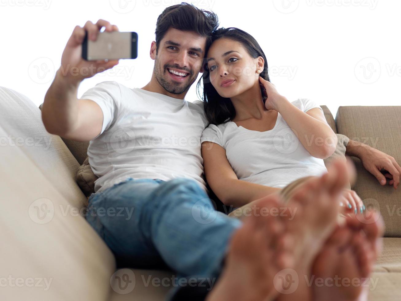 young couple making selfie together at home photo