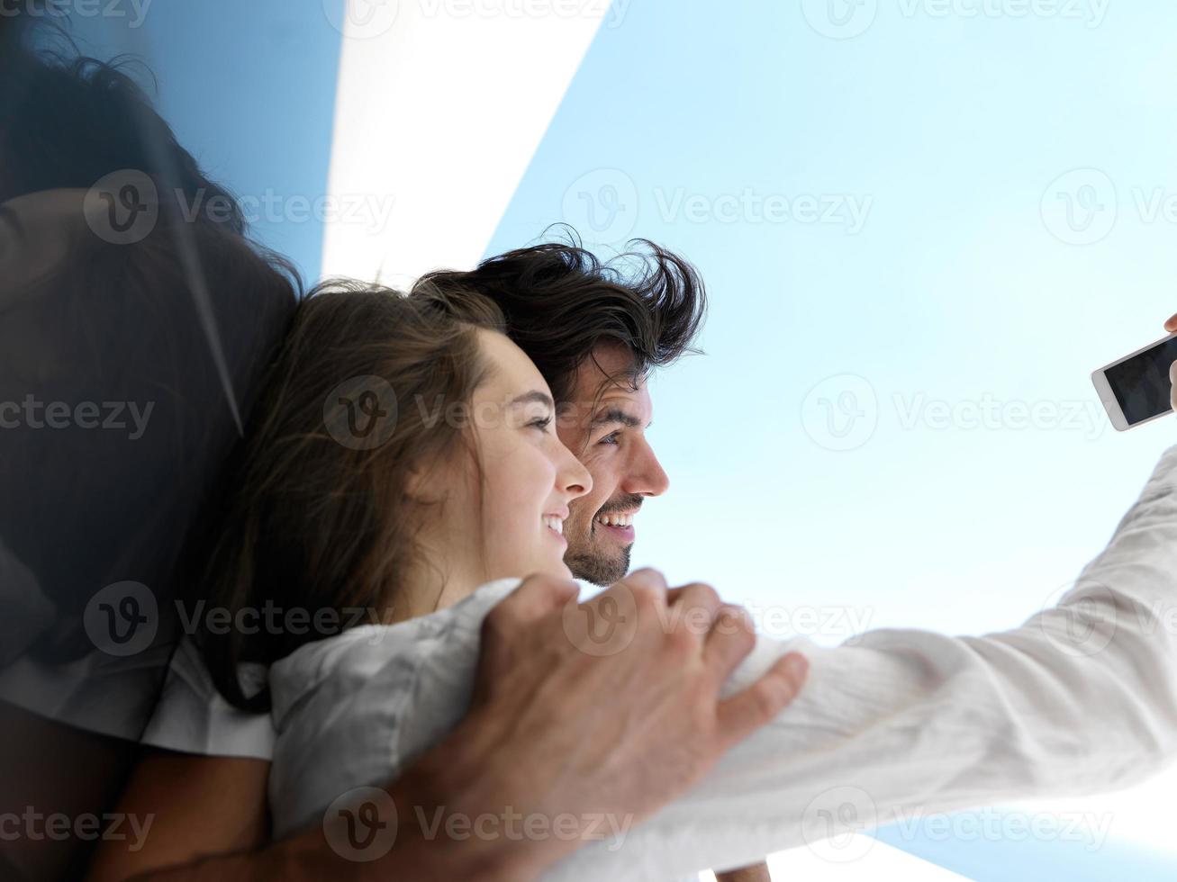 young couple making selfie together at home photo