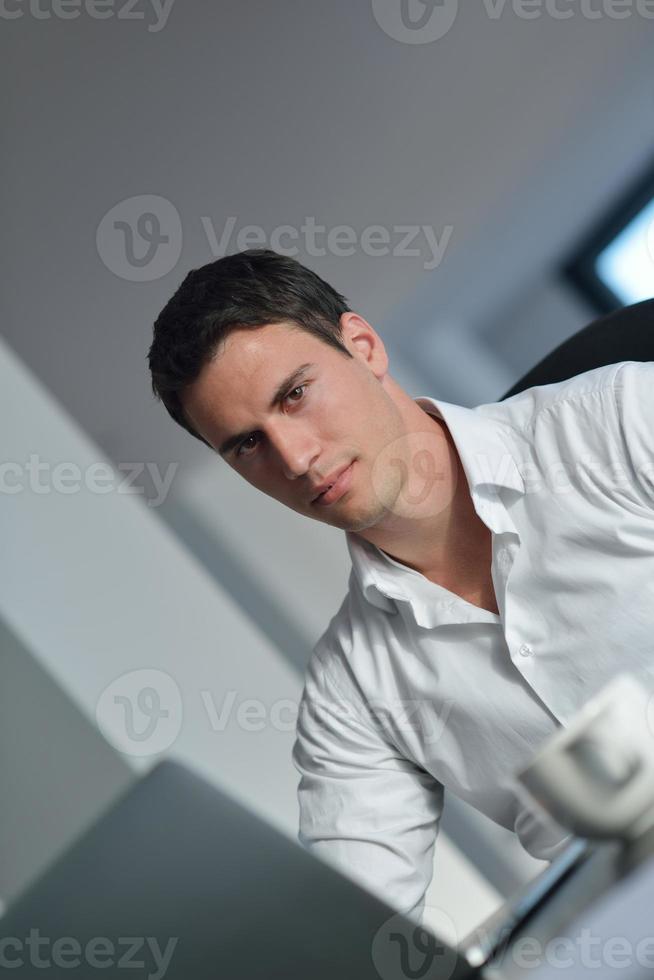 business man working on laptop computer at home photo