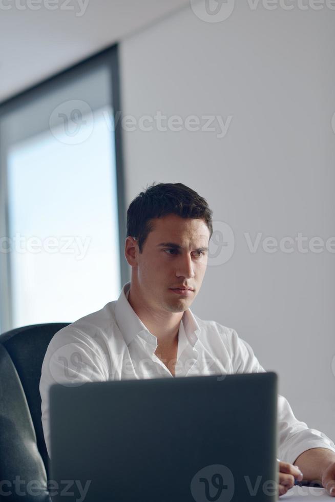 business man working on laptop computer at home photo