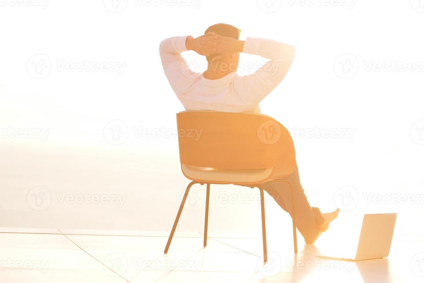 relaxed young man at home on balcony photo