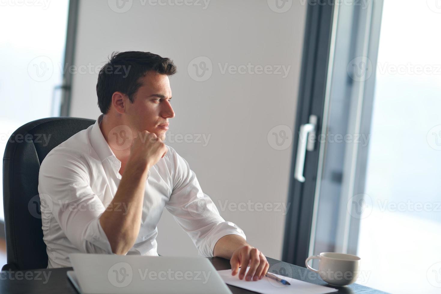 business man working on laptop computer at home photo