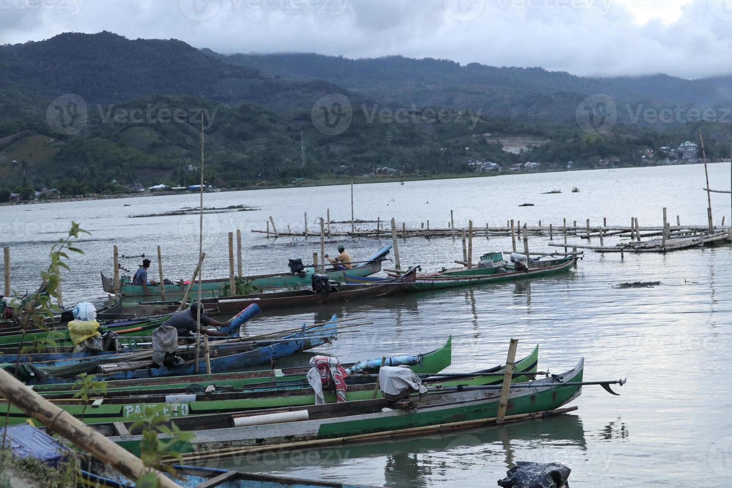 Traditional fishing boat anchored by the lake photo