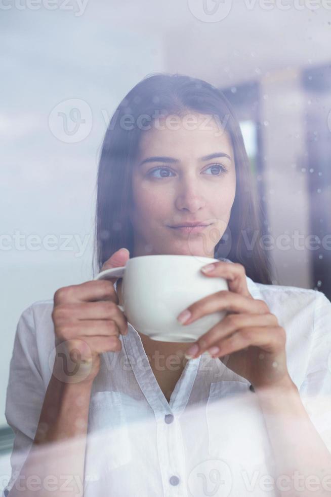 beautiful young woman drink first morning coffee photo