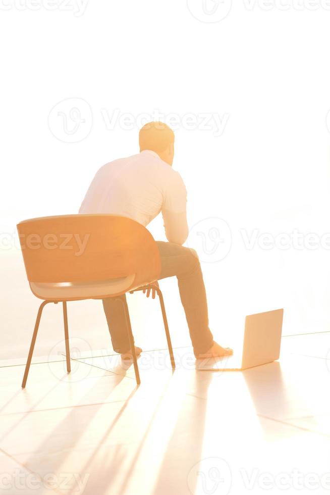 relaxed young man at home on balcony photo