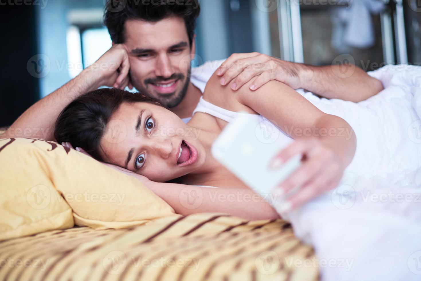 couple relax and have fun in bed photo