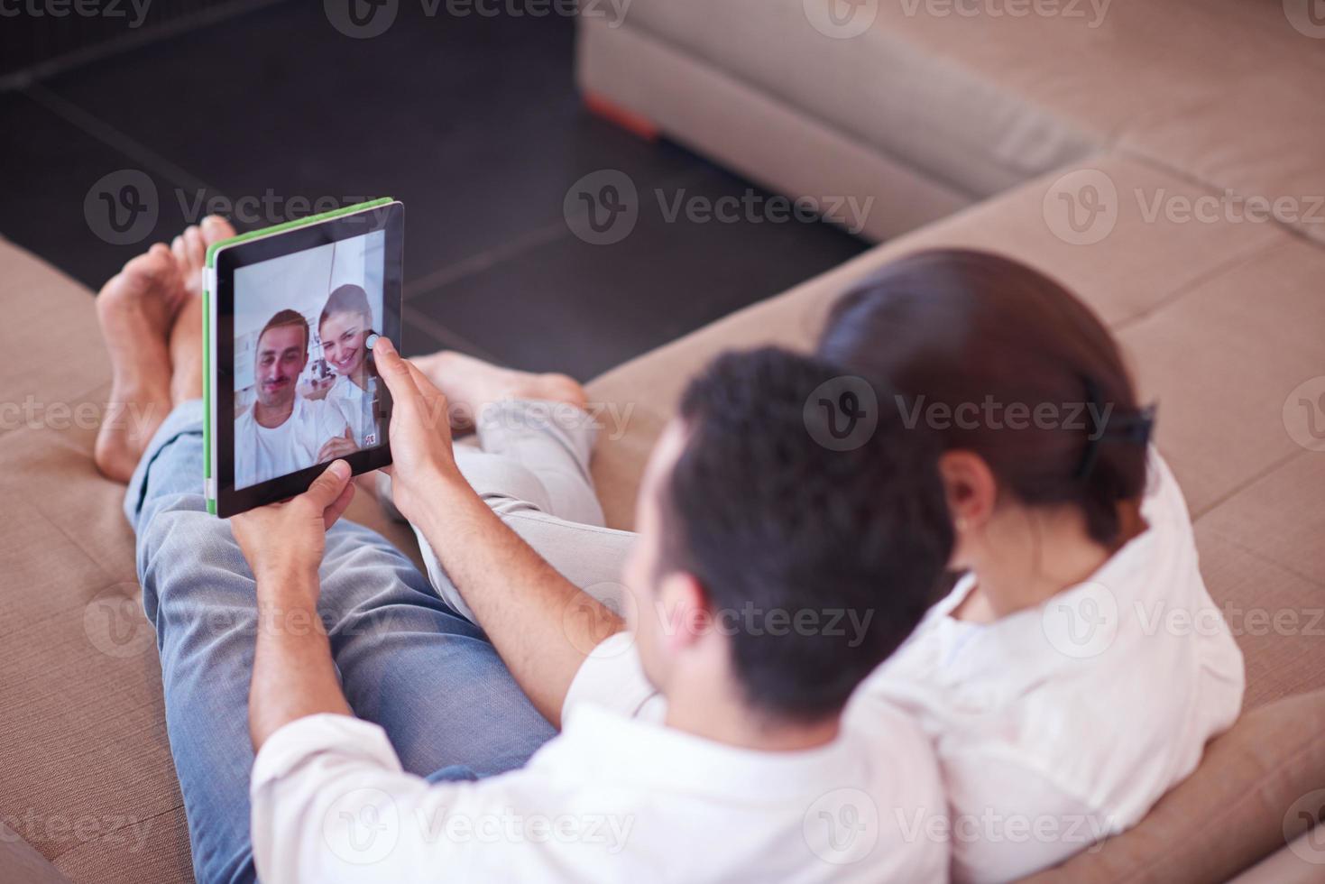 couple at modern home using tablet computer photo