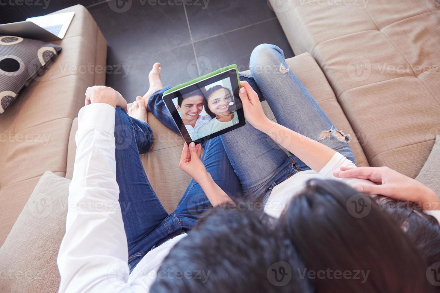 couple at modern home using tablet computer photo