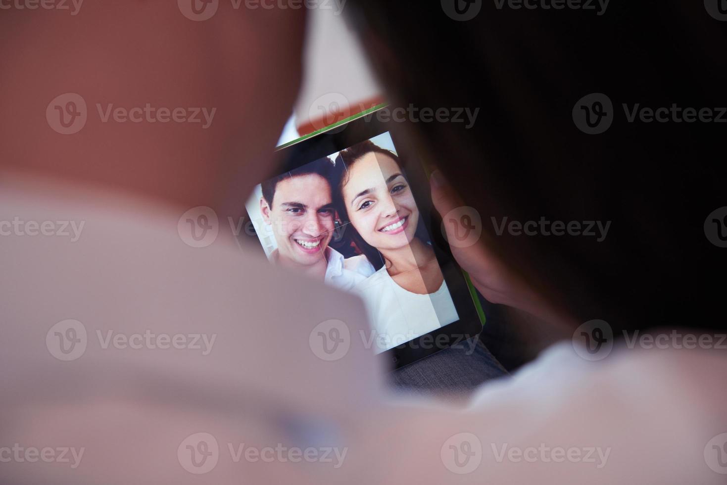 couple at modern home using tablet computer photo