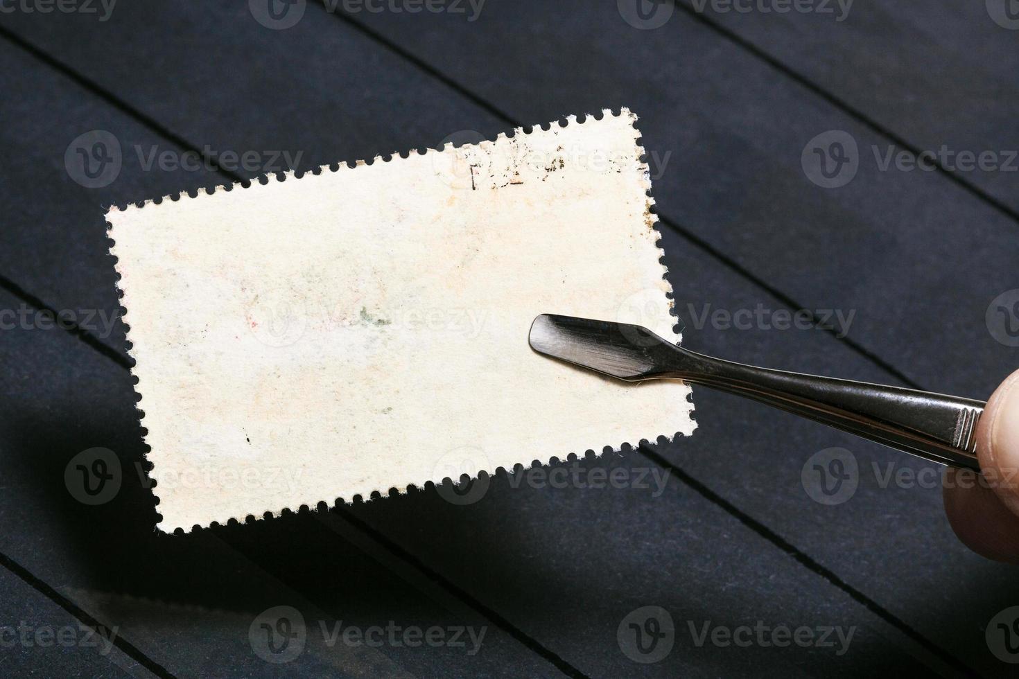 tongs keeps postage stamp with unused back side photo