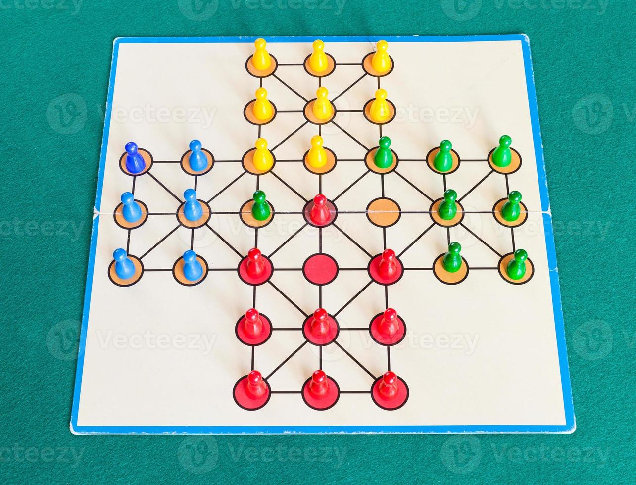 gameplay of solitaire board game on green table photo