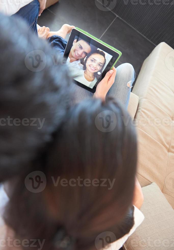 couple at modern home using tablet computer photo