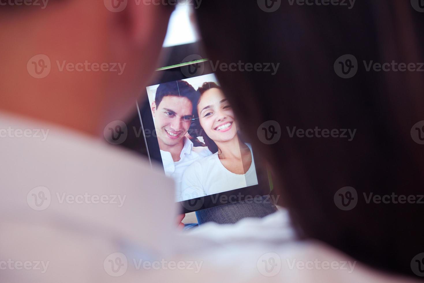 couple at modern home using tablet computer photo