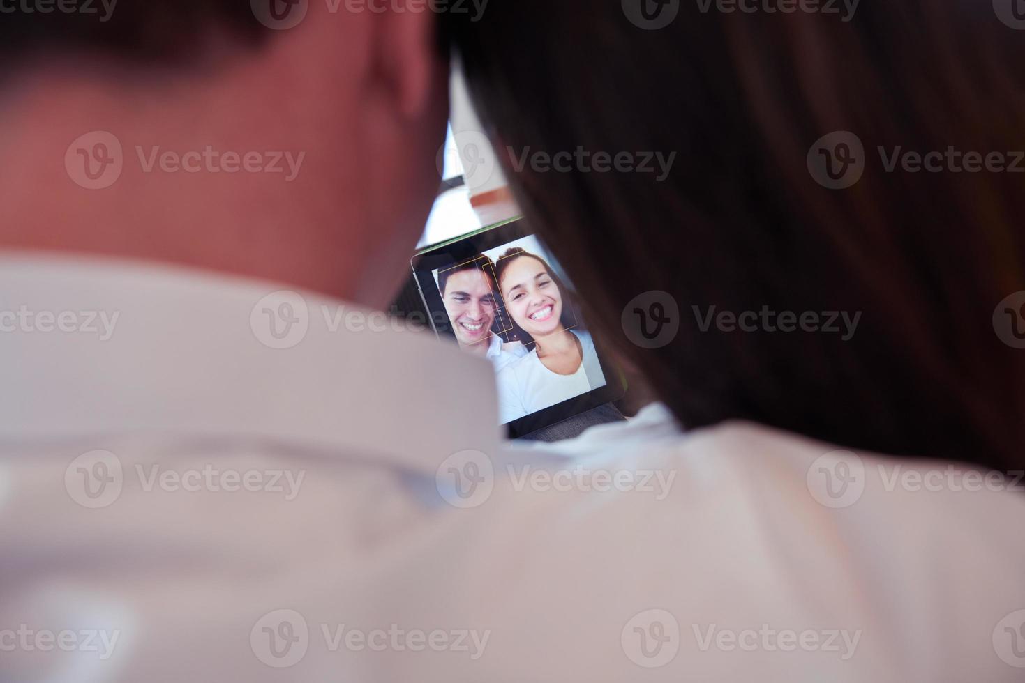 couple at modern home using tablet computer photo