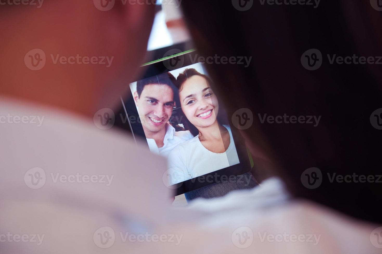 couple at modern home using tablet computer photo