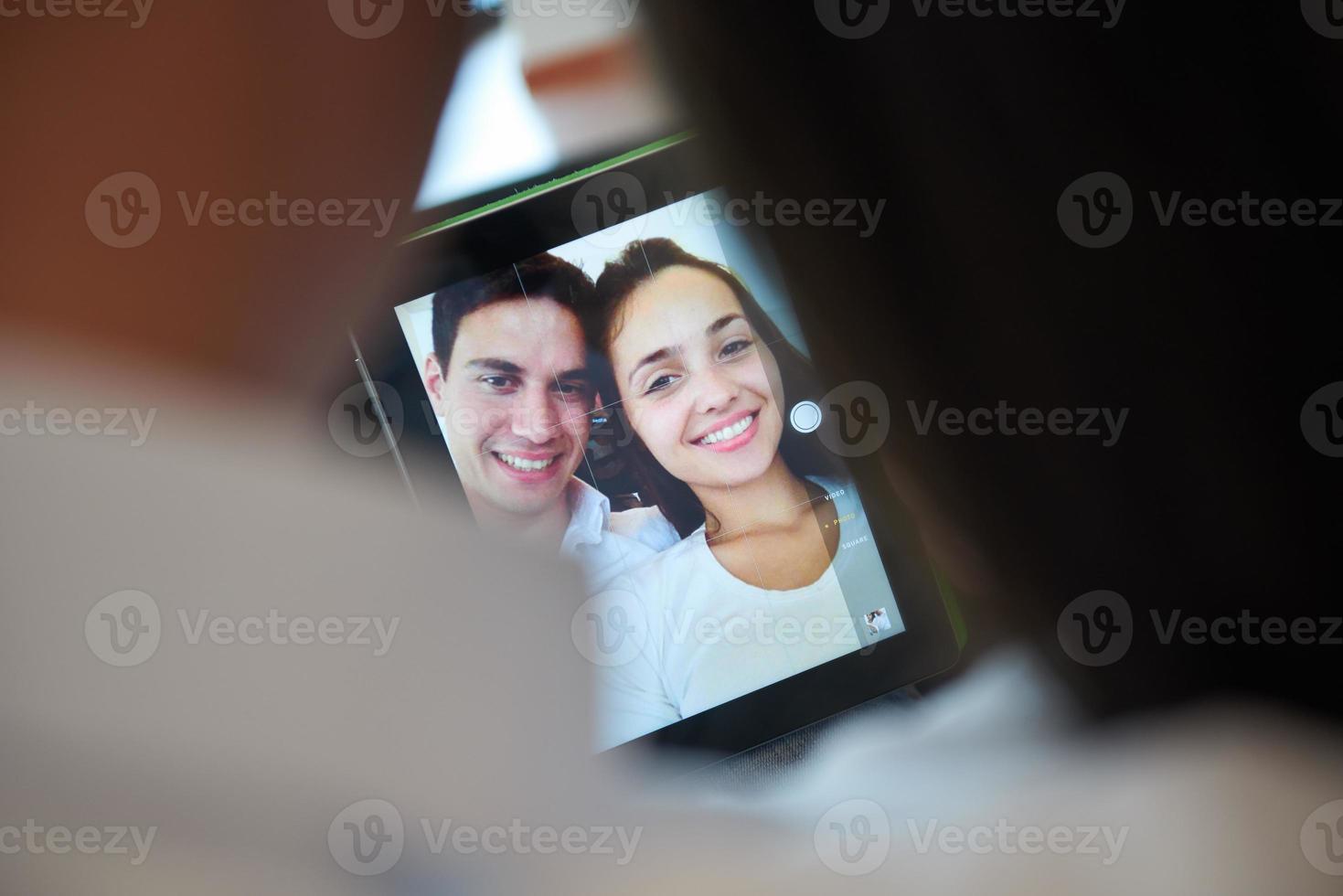 couple at modern home using tablet computer photo