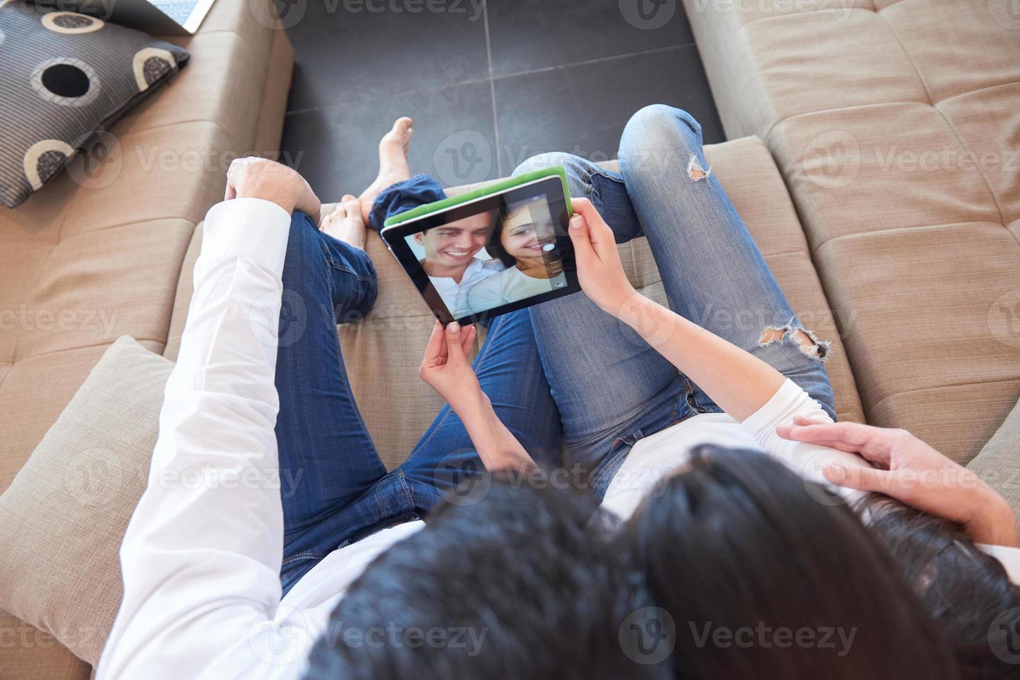 couple at modern home using tablet computer photo