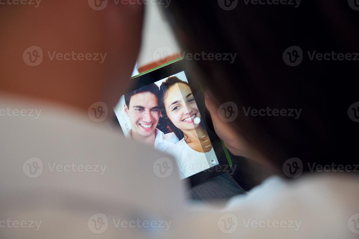 couple at modern home using tablet computer photo
