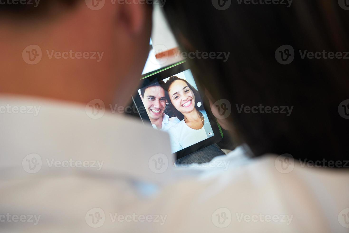 couple at modern home using tablet computer photo