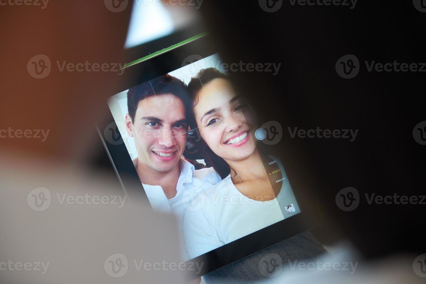 couple at modern home using tablet computer photo