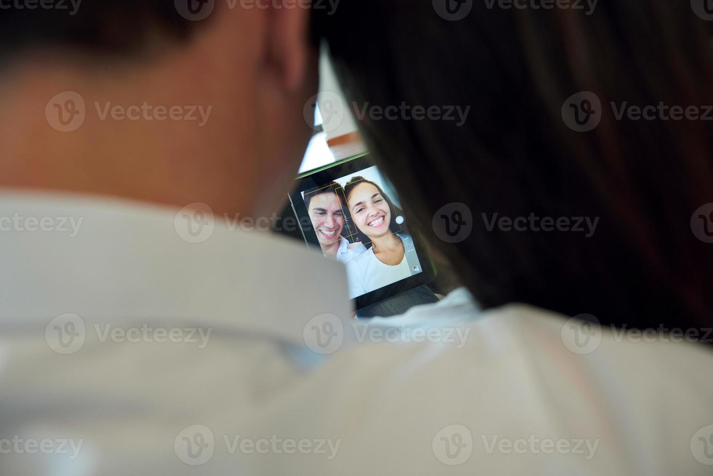 couple at modern home using tablet computer photo