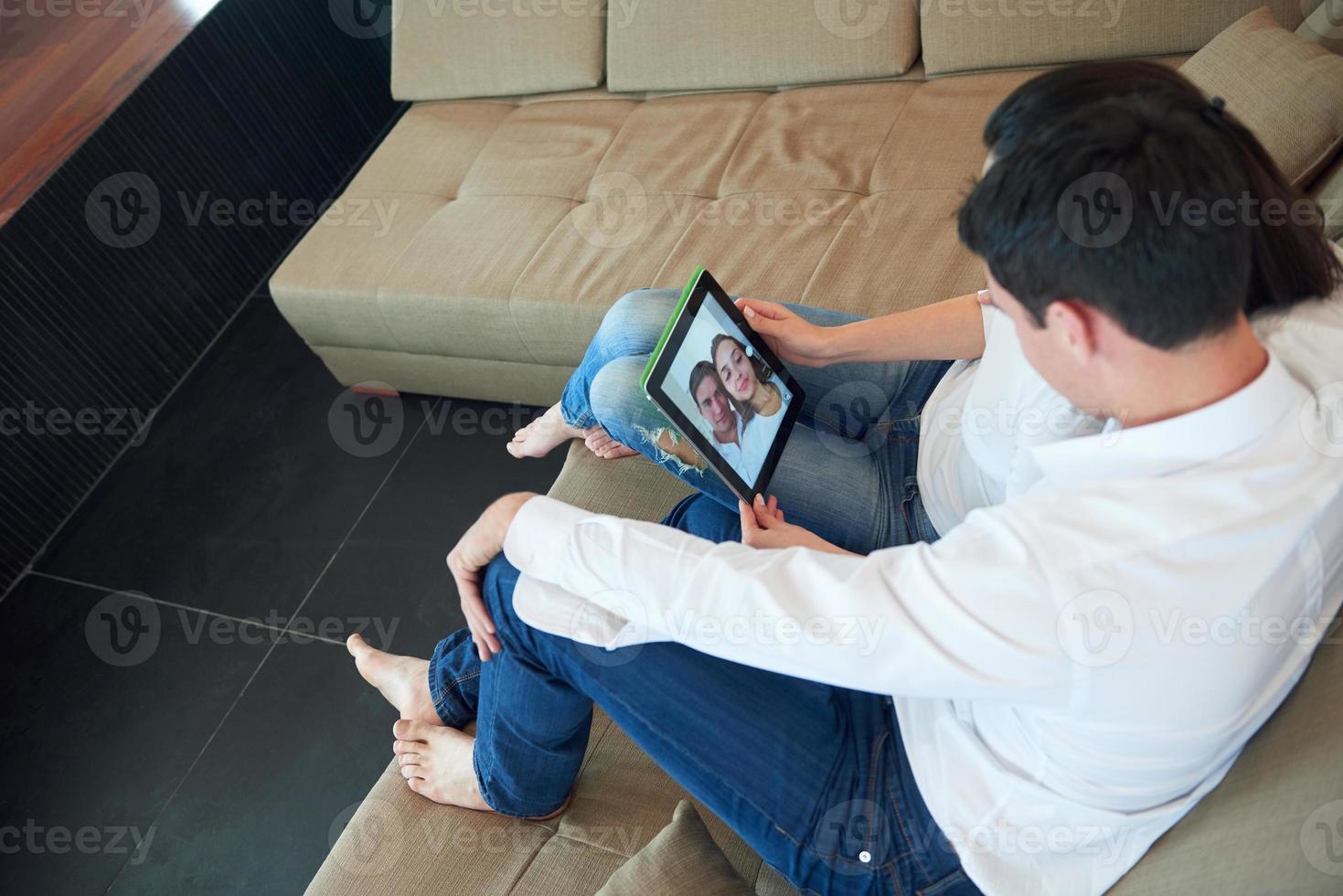 couple at modern home using tablet computer photo