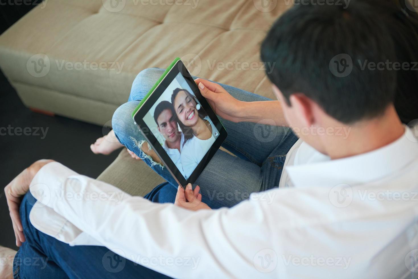 couple at modern home using tablet computer photo
