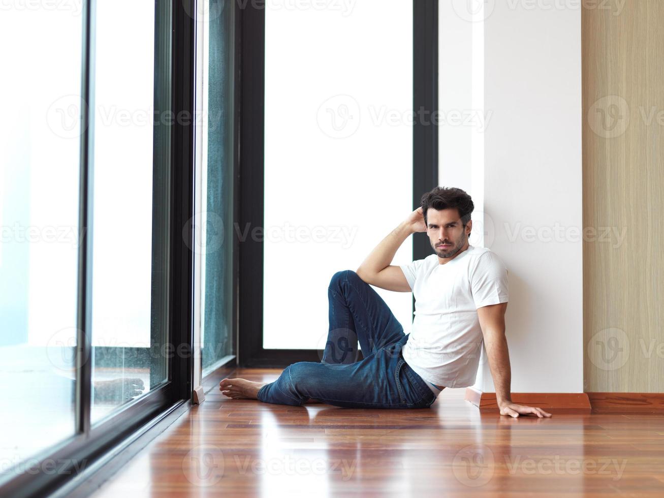 relaxed young man drink first morning coffee photo