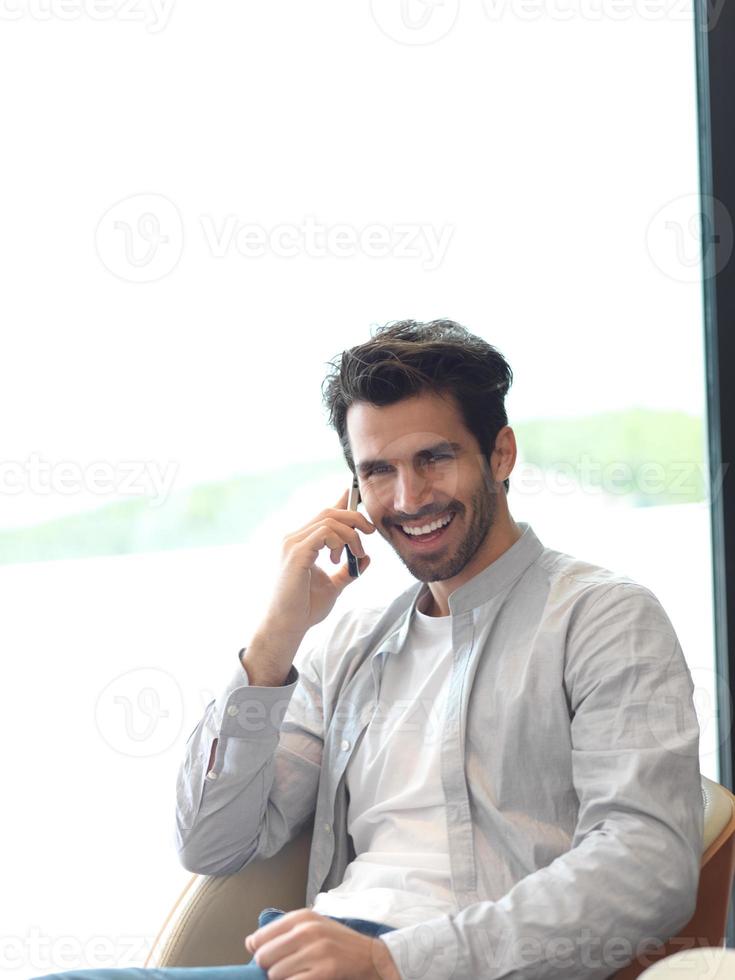 relaxed young man drink first morning coffee photo