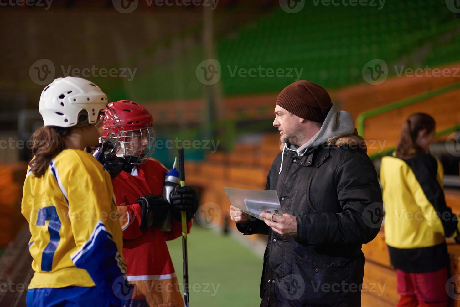 teen ice hockey players team meeting with trainer photo