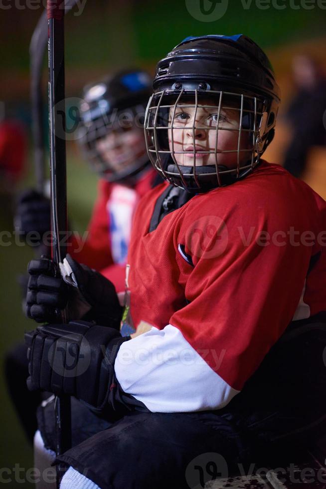 children ice hockey players on bench photo