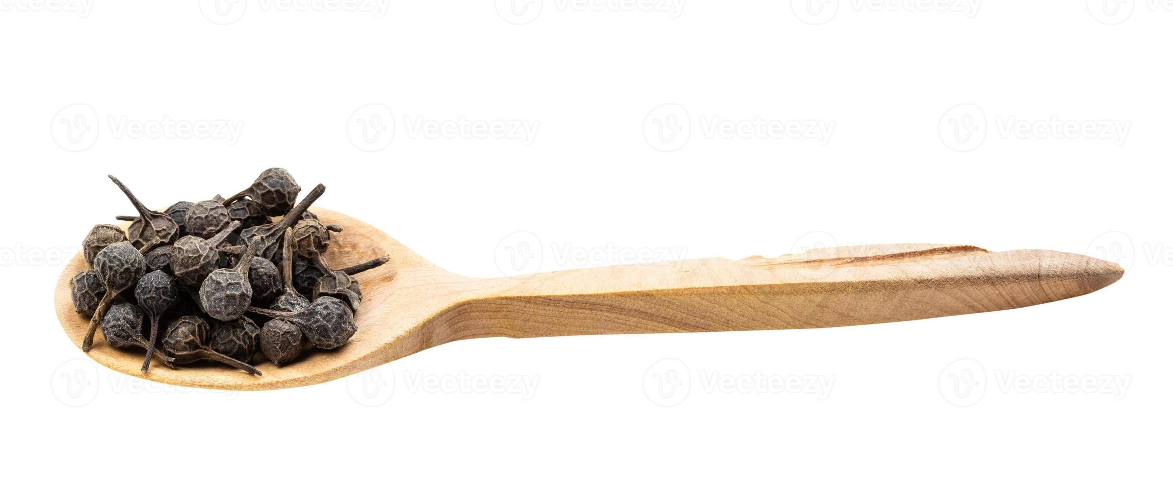 tailed pepper cubeb in wooden spoon isolated photo