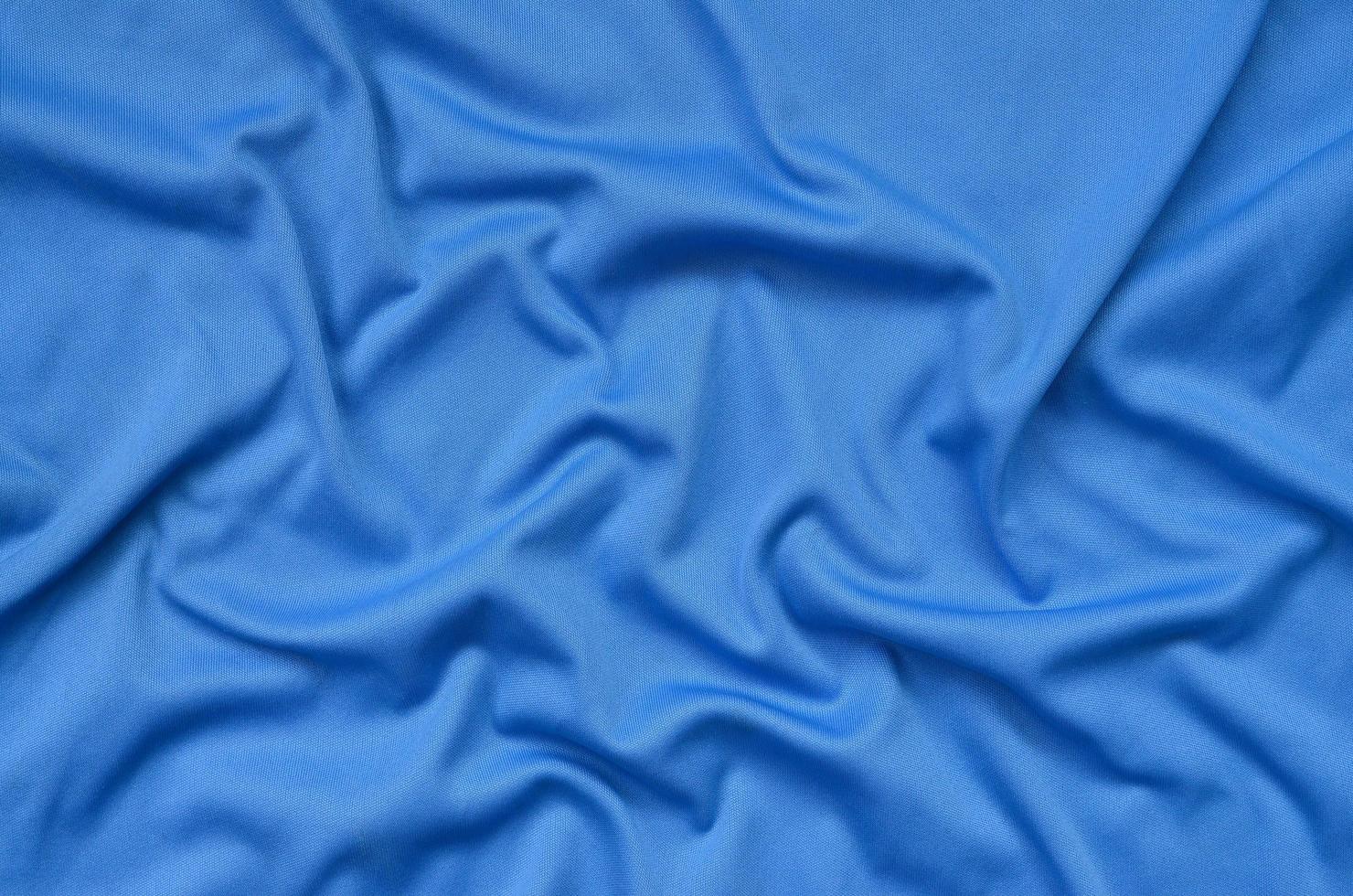 Detailed polyester blue fabric texture with many folds photo