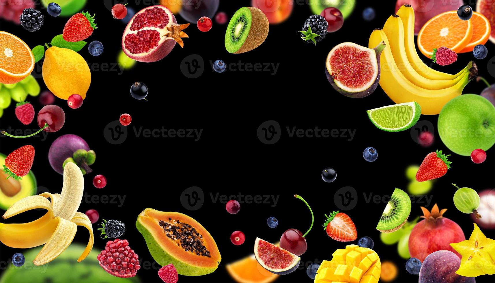 Frame made of fruits and berries isolated on black background photo