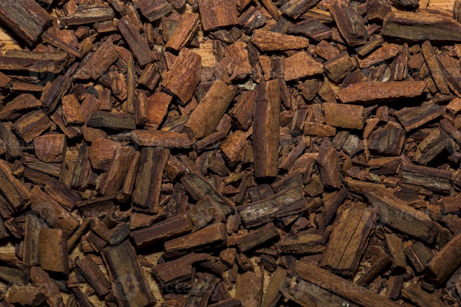 Background of crushed cinnamon sticks for making a tea mixture. Cinnamon texture. photo