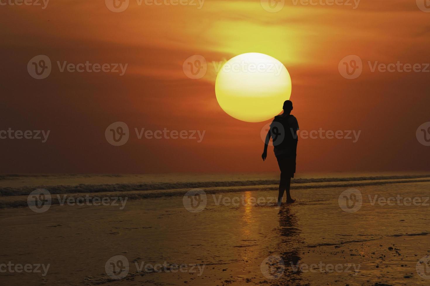 silhouette man and sea sunset photo