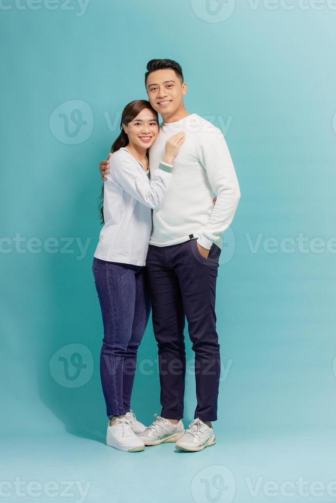 Image of happy young loving couple hugging isolated over blue background. photo