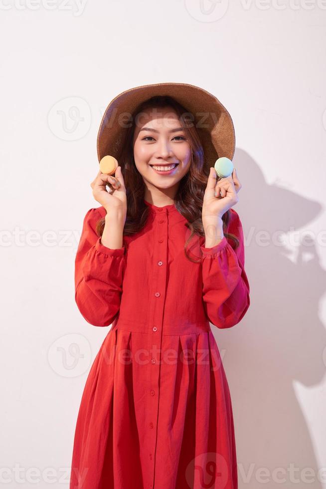 Happy girl plays with macaroons. photo