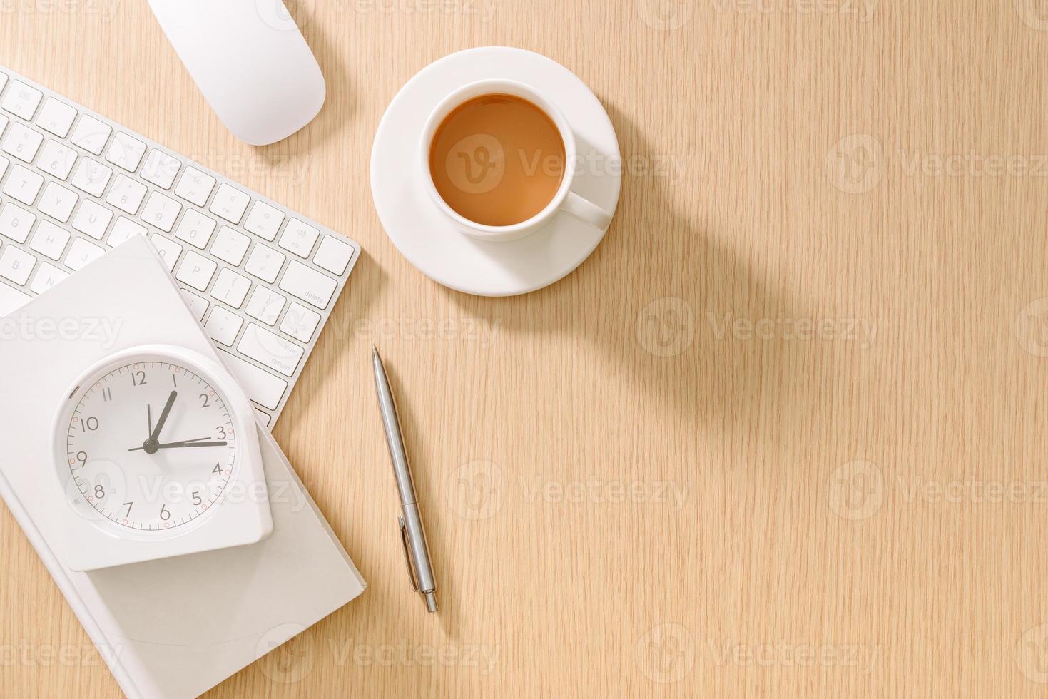 Modern white office desk with keyboard, mouse, oclock, book, pen and cup of coffee.Top view with copy paste. Business and strategy concept mockup. photo