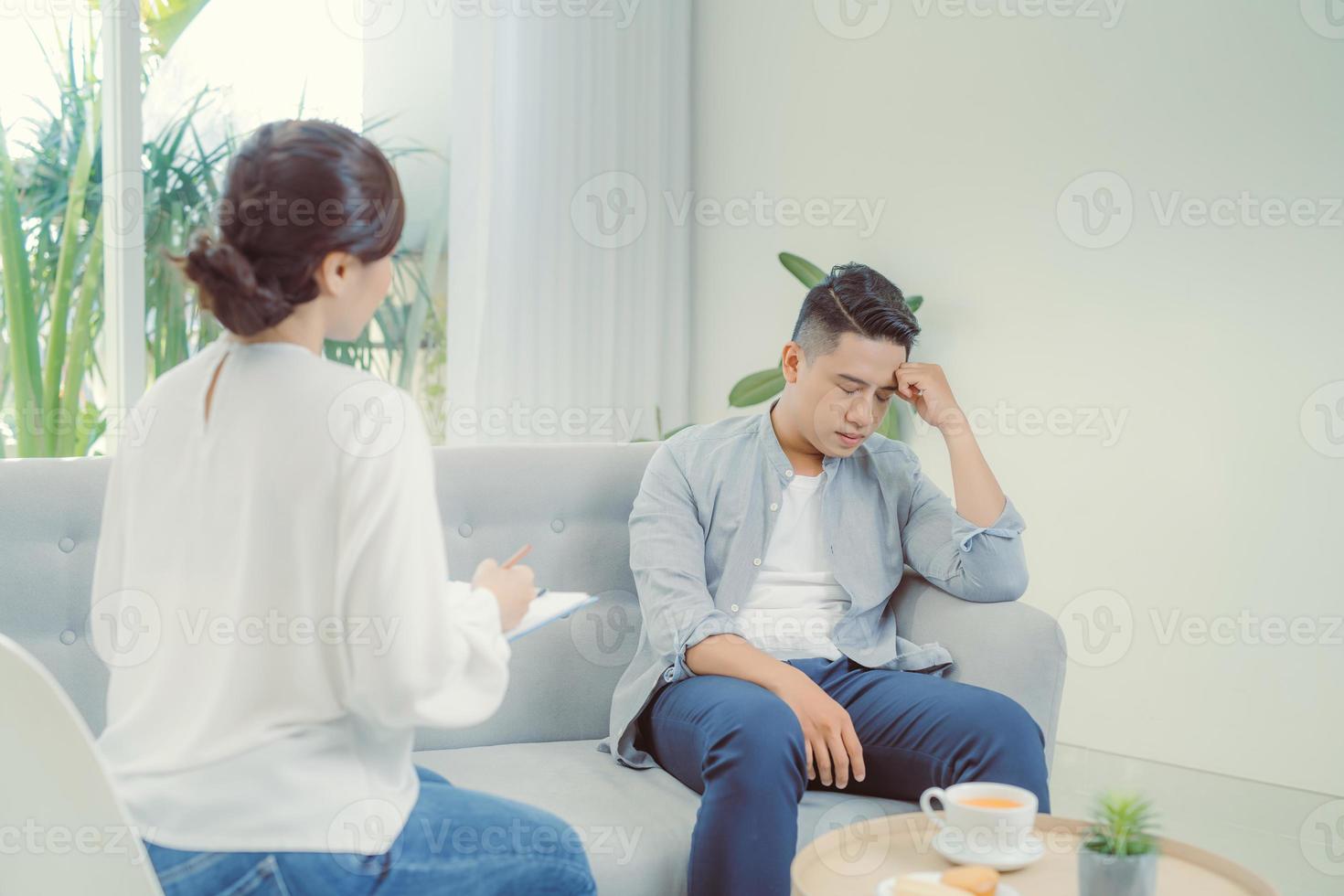 Famale psychiatrist listening to her patient who experienced traumatic events photo