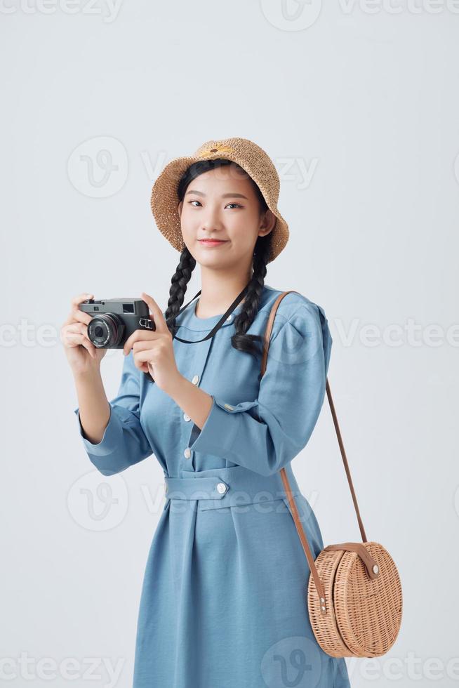 Young cute smiling girl taking pictures on a compact camera photo