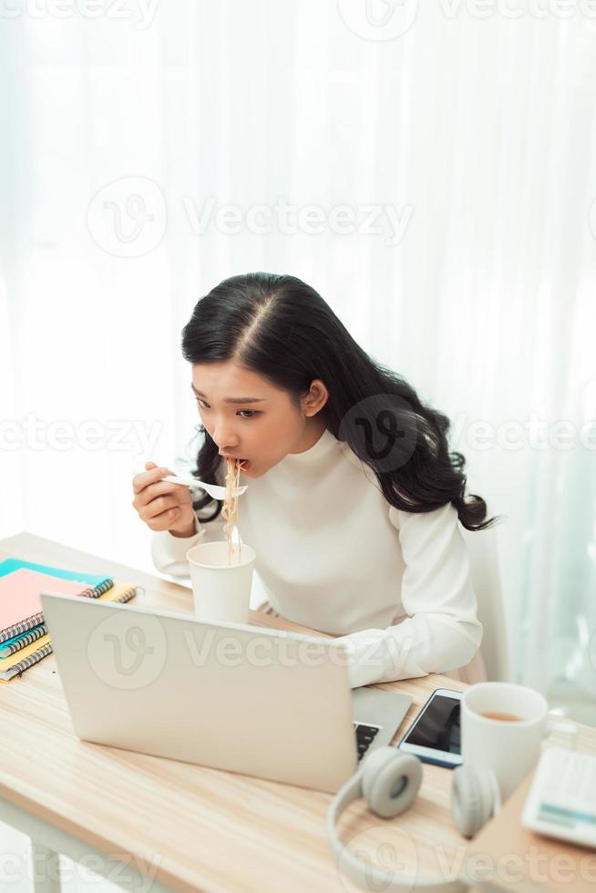 Young Asian girl sitting on desk work overtime, enjoy relax time.female working . photo