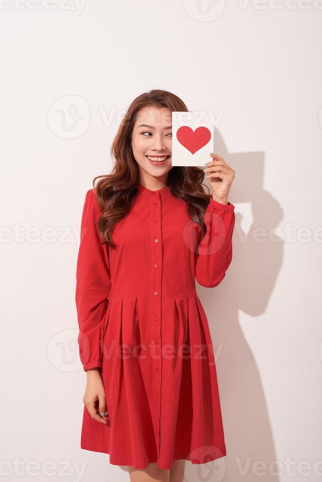 Portrait of happy romantic girl with red paper heart-shaped postcard, romantic wishes, Valentine day celebration, love concept photo