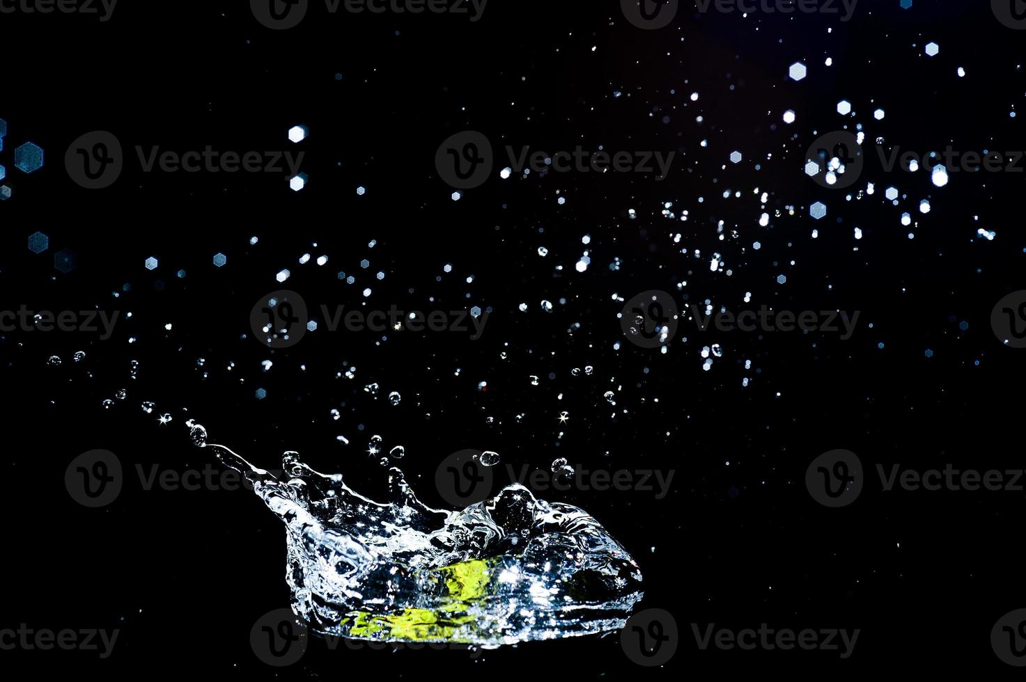 Scattered water splashes on a black background. water splash isolated on the black background photo