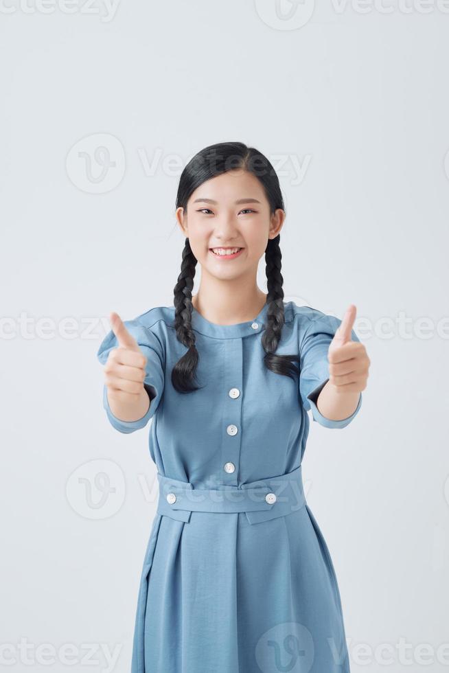 exited woman giving double thumb up studio isolated portrait photo