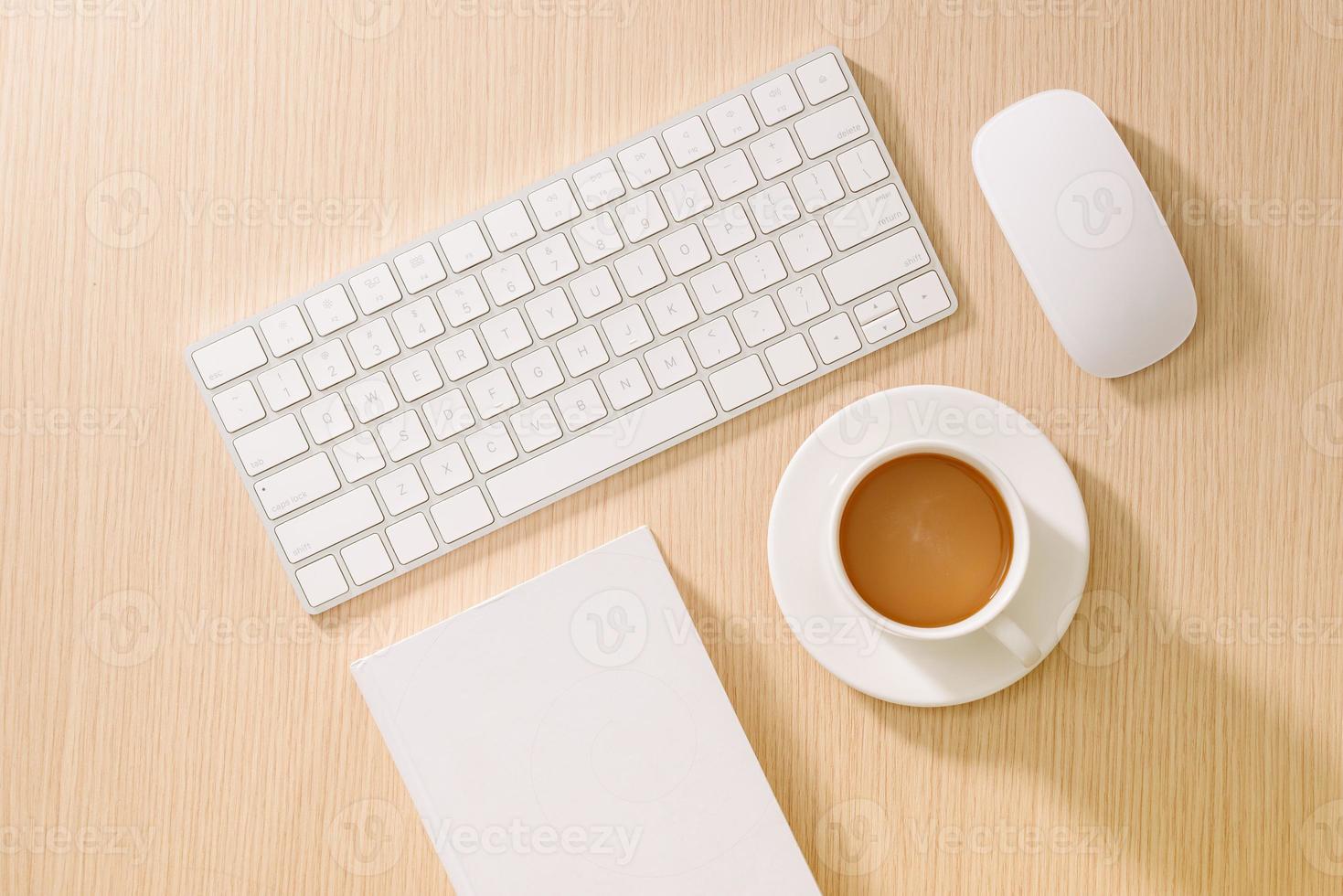 Flat lay, top view office table desk. Workspace with blank note book, keyboard, office supplies and coffee cup on wooden background. photo