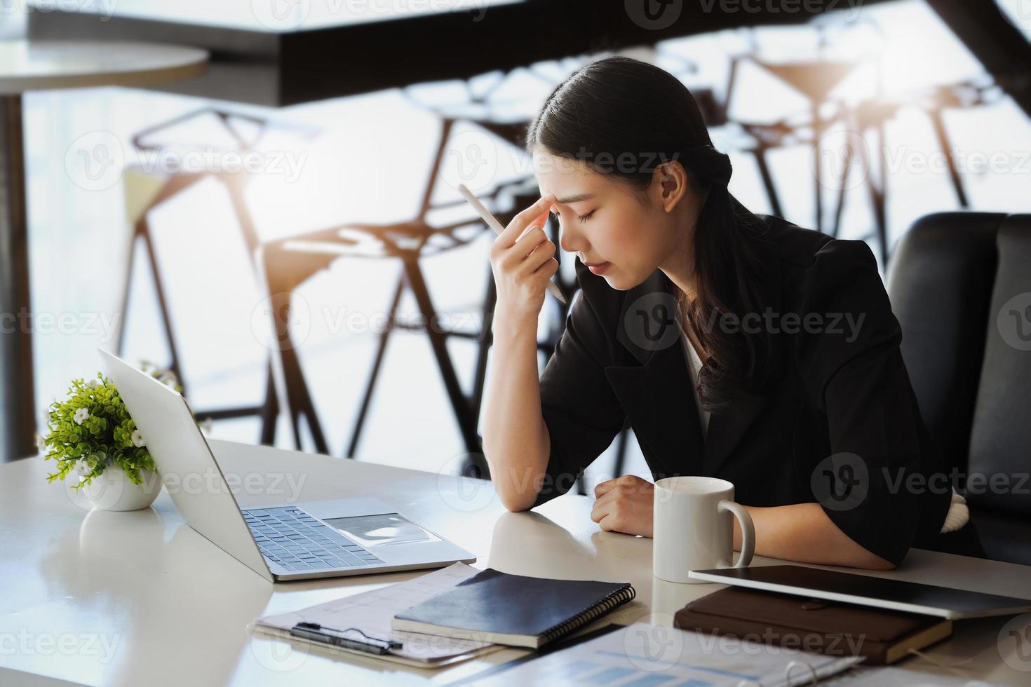 Company employees show boredom from unfinished work using computer notebook, documents and tablets at work. photo
