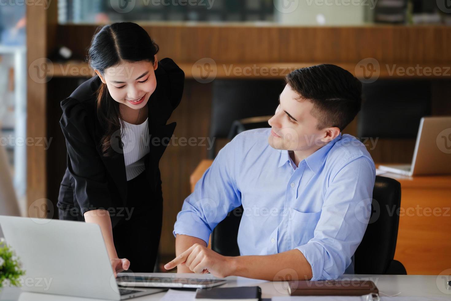 The male marketing manager expressed his satisfaction in selling the company's products. where team members show sales from their iPad screen. photo