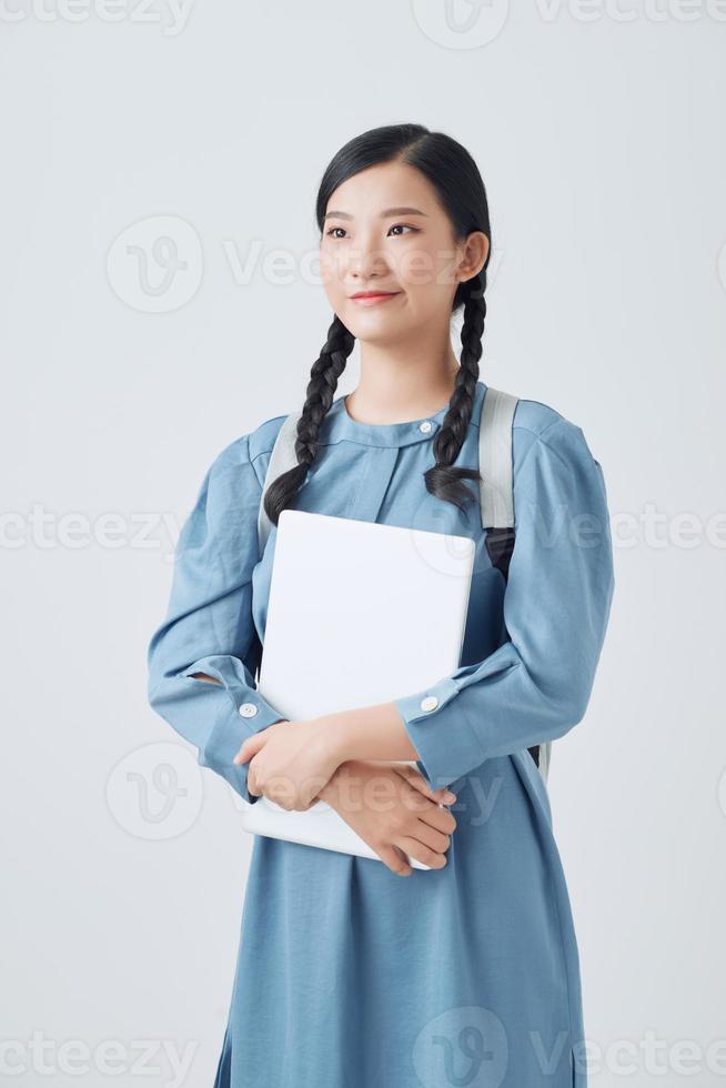 Young Asian student isolated on white background. photo